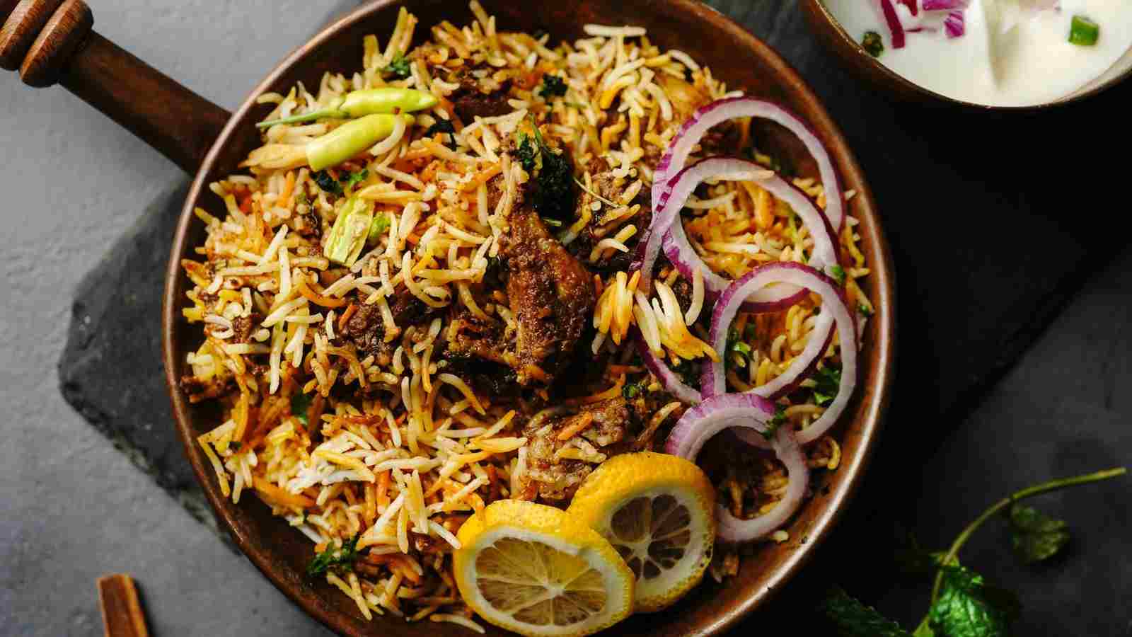 Just had the most incredible Best biryani in Pondicherry! a bowl of food with meat and vegetables.