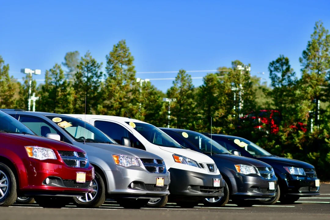 Many cars are parked outside for car rentals.